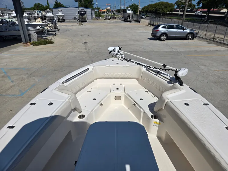 Slide: The Image of 2021 Blue Wave 2800 Makaira boat storage compartment with open lid and cushioned seating. - 11