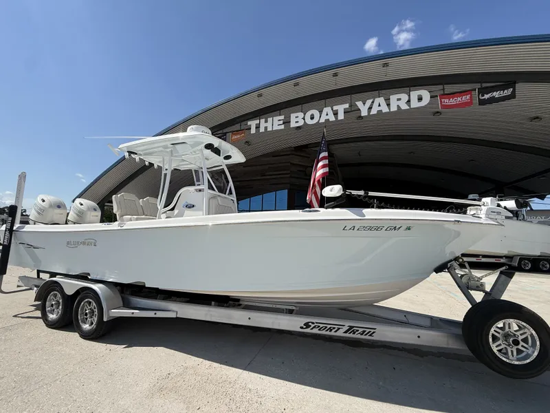 Slide: The Image of 2021 Blue Wave 2800 Makaira boat interior with dual seats and Suzuki engines. - 14