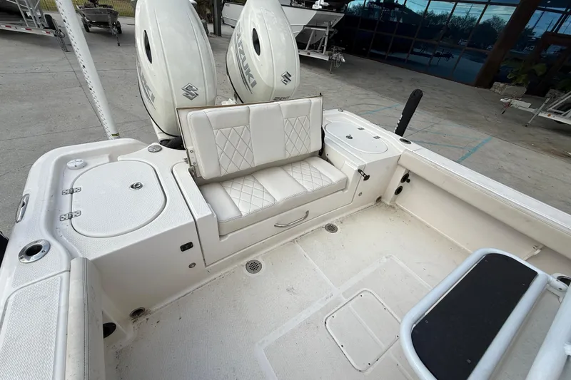 Slide: The Image of 2021 Blue Wave 2800 Makaira boat interior with dual Suzuki engines and cushioned seating. - 15