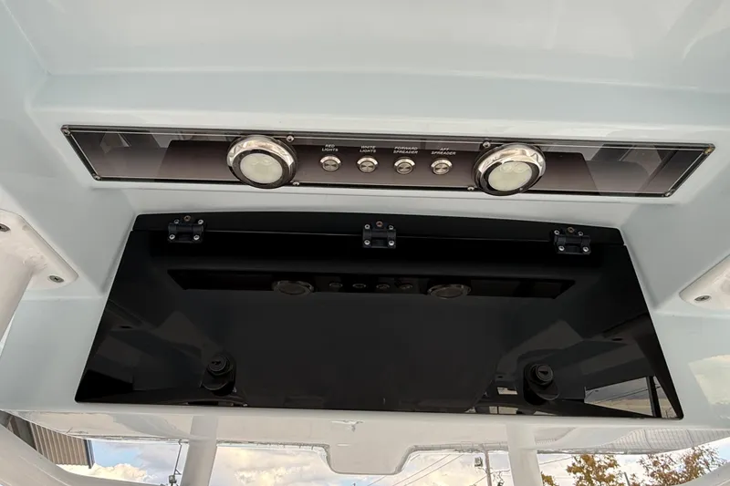 Slide: The Image of 2021 Blue Wave 2800 Makaira boat console with control panel and lighting switches. - 18