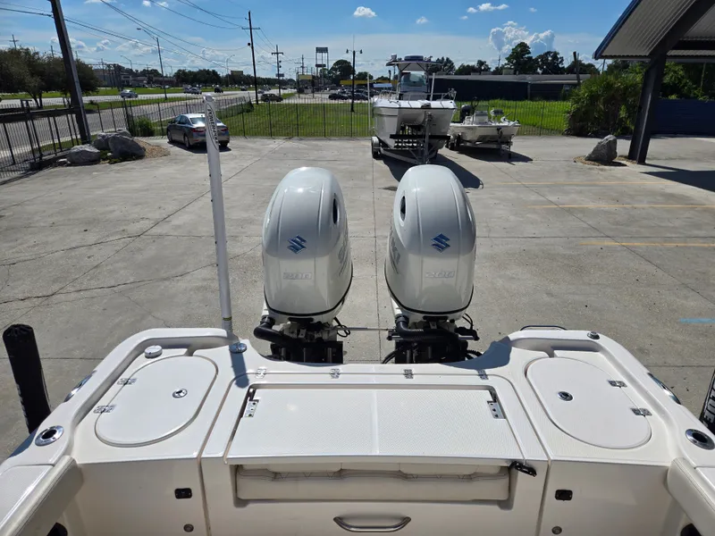 Slide: The Image of 2021 Blue Wave 2800 Makaira boat on trailer, parked outdoors under cloudy sky. - 3