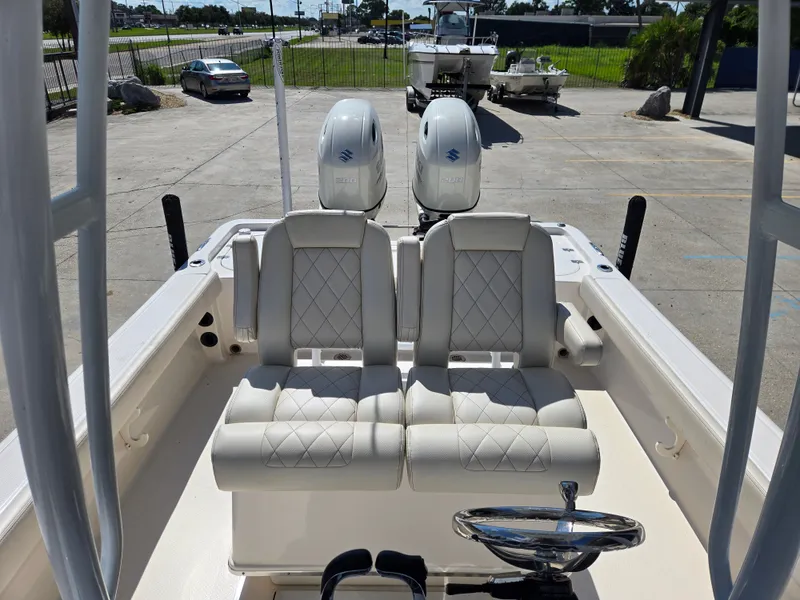 Slide: The Image of 2021 Blue Wave 2800 Makaira boat with dual outboard engines, parked outdoors. - 5