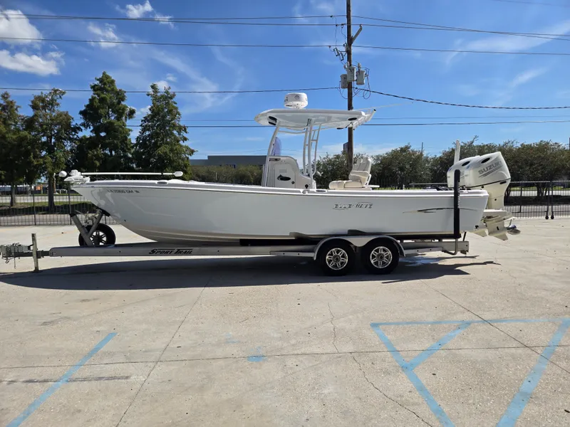 Slide: The Image of 2021 Blue Wave 2800 Makaira boat interior with seating and console, docked outdoors. - 7