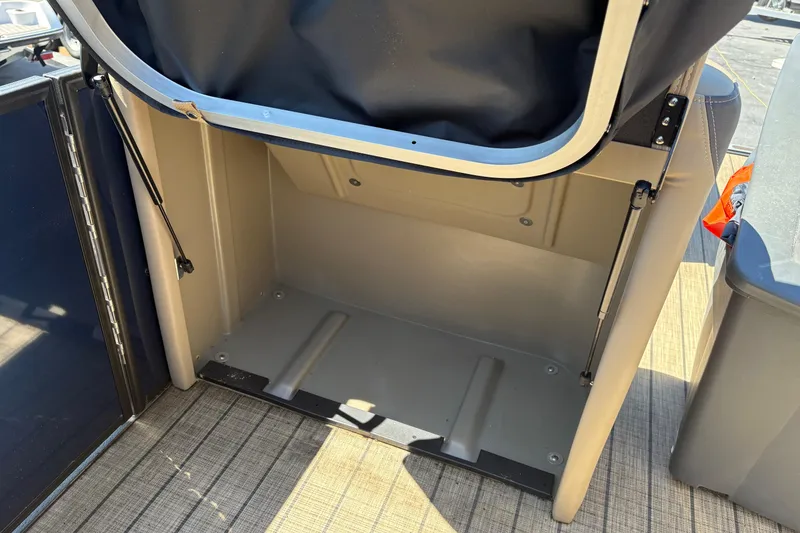 Slide: The Image of 2024 Sylvan L3 CLZ boat storage compartment with open hatch and hydraulic supports. - 10