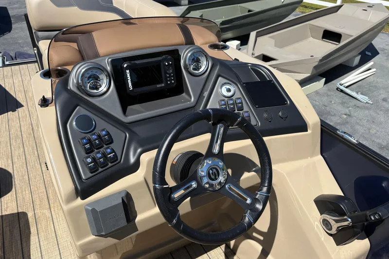 Slide: The Image of 2024 Sylvan L3 CLZ boat dashboard with steering wheel and control panel. - 11
