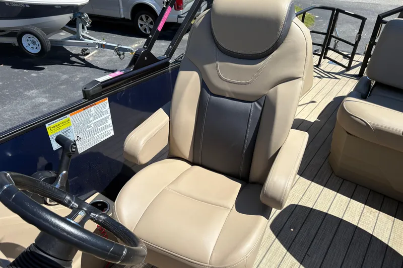 Slide: The Image of Captain's chair in 2024 Sylvan L3 CLZ boat, featuring beige and black upholstery. - 13