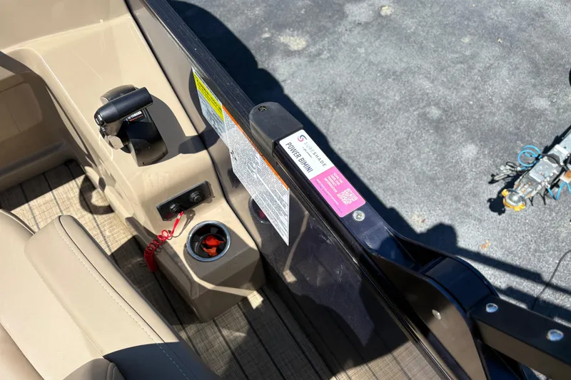Slide: The Image of 2024 Sylvan L3 CLZ boat interior with control panel and cup holder. - 14