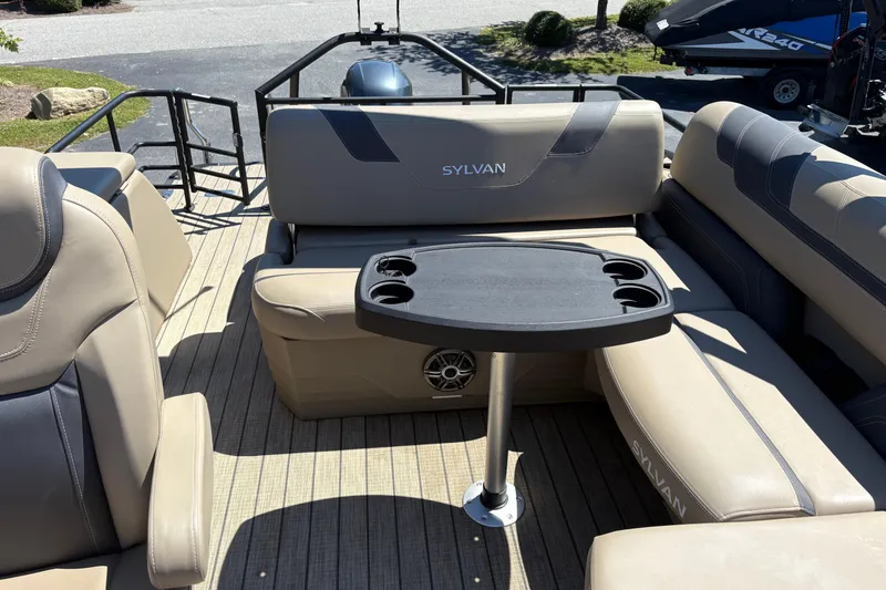 Slide: The Image of 2024 Sylvan L3 CLZ boat interior with beige seating and a black table. - 18