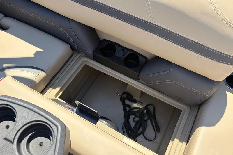 Slide: The Image of 2024 Sylvan L3 CLZ boat interior with storage compartment and cup holders. - 19
