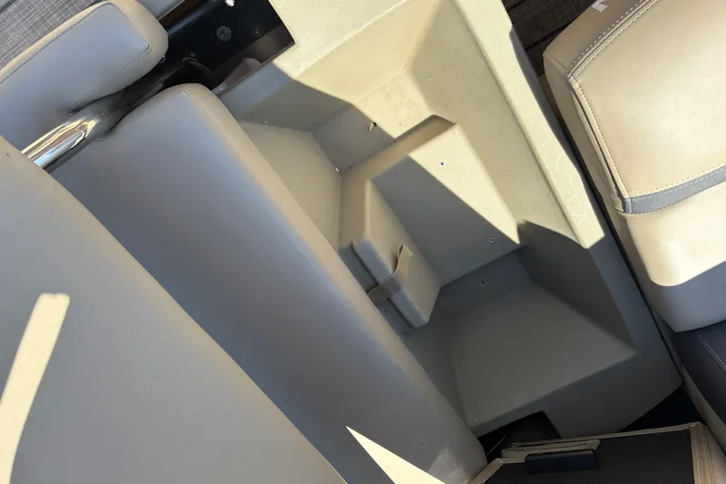Slide: The Image of Interior view of 2024 Sylvan L3 CLZ boat seating area with storage compartment. - 21