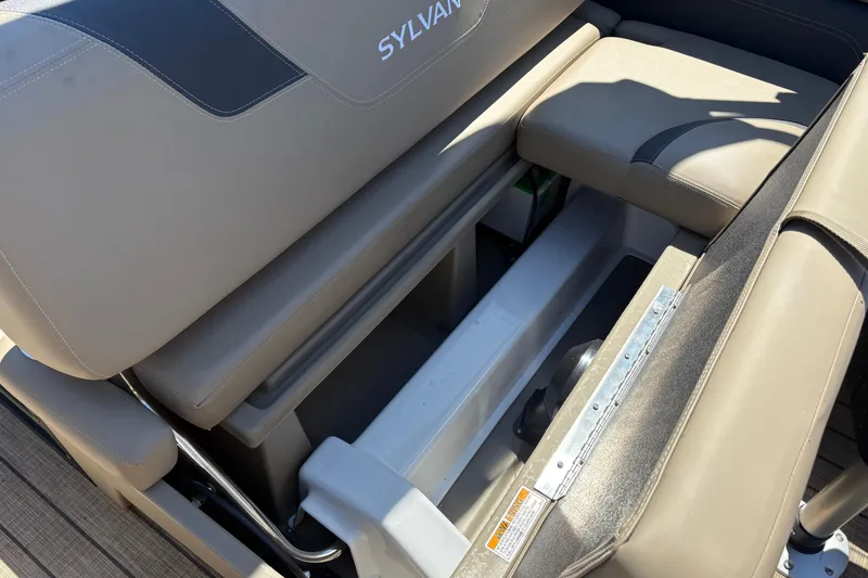 Slide: The Image of 2024 Sylvan L3 CLZ boat interior seating with storage compartment open. - 22