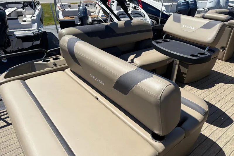 Slide: The Image of 2024 Sylvan L3 CLZ boat interior with beige seating and cup holders. - 24