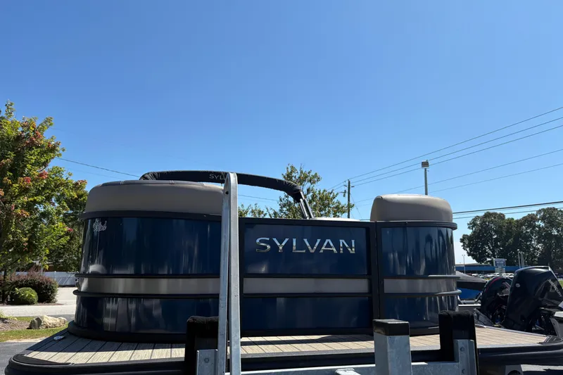 Slide: The Image of 2024 Sylvan L3 CLZ pontoon boat on trailer under clear blue sky. - 3