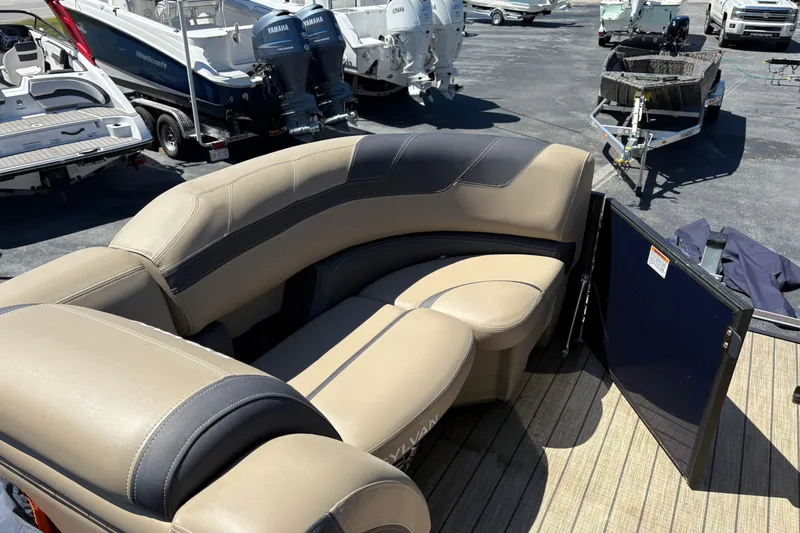 Slide: The Image of 2024 Sylvan L3 CLZ pontoon boat with beige seating and open gate. - 5