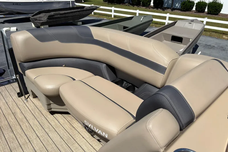 Slide: The Image of 2024 Sylvan L3 CLZ boat interior with beige and gray seating. - 8