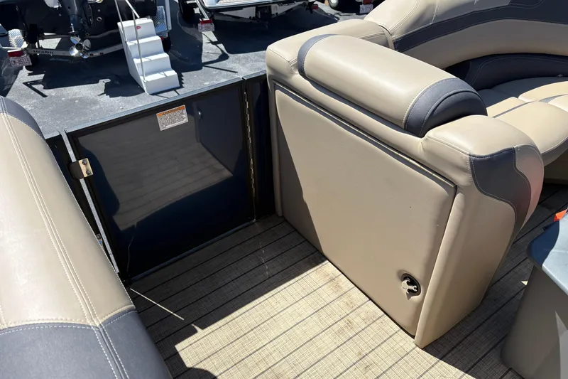 Slide: The Image of 2024 Sylvan L3 CLZ boat interior with beige seating and flooring. - 9