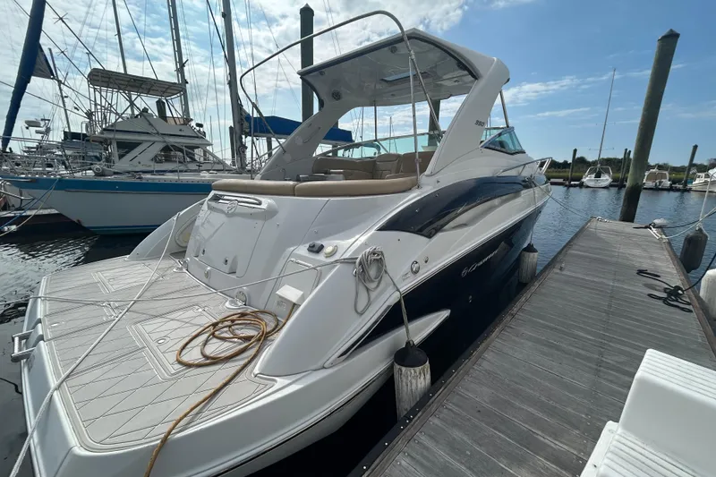 Slide: The Image of 2015 Crownline 350 SY yacht docked at marina, showcasing sleek design and spacious deck. - 2