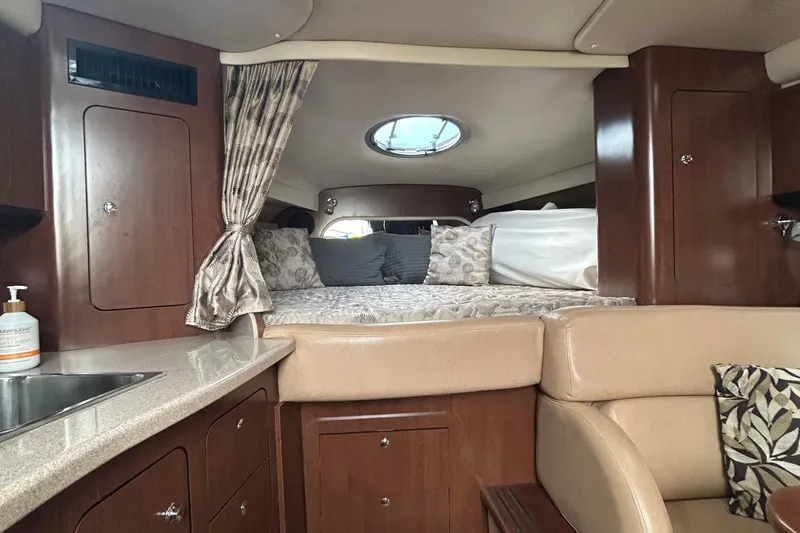 Slide: The Image of Interior of 2015 Crownline 350 SY yacht with cozy bed and elegant wood finish. - 21