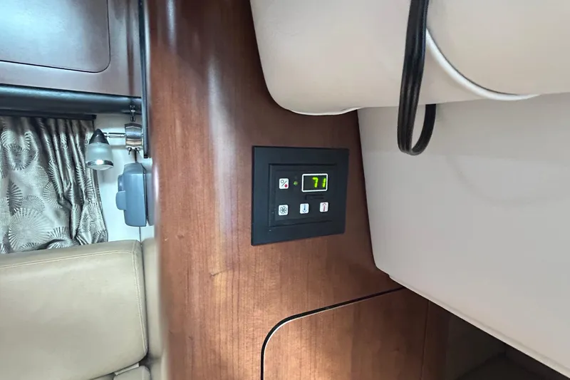 Slide: The Image of Control panel inside 2015 Crownline 350 SY yacht, featuring wood paneling and modern design. - 26