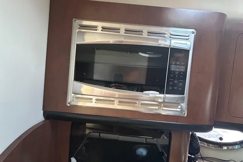 Slide: The Image of Frigidaire microwave in 2015 Crownline 350 SY yacht kitchen interior. - 27