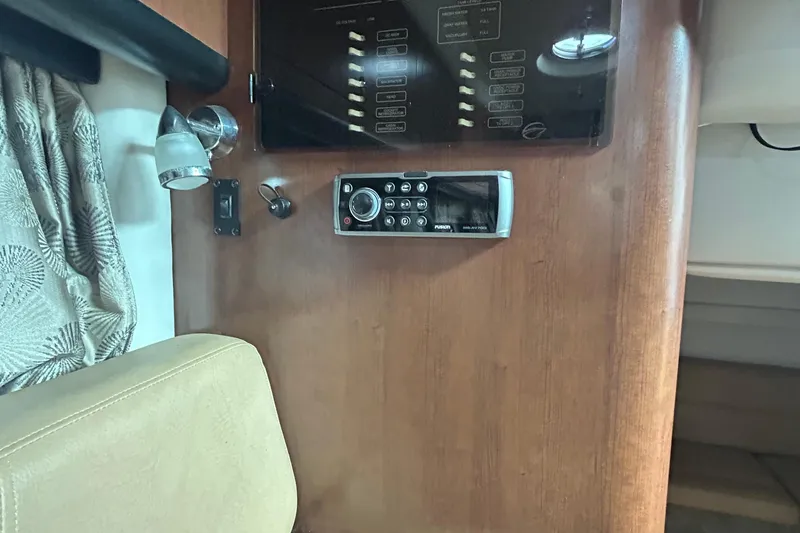 Slide: The Image of Control panel and radio on 2015 Crownline 350 SY boat interior. - 29
