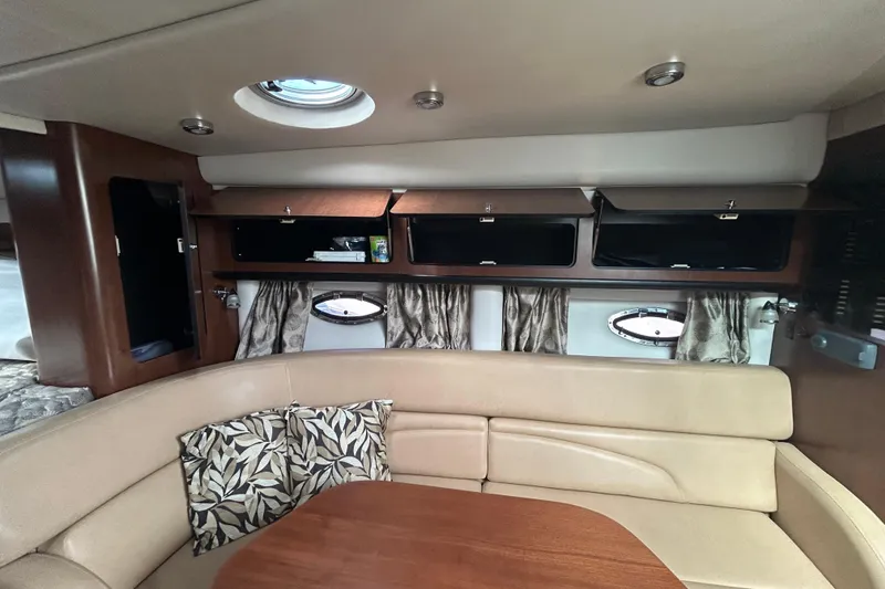 Slide: The Image of Interior of 2015 Crownline 350 SY yacht with beige seating and wooden cabinetry. - 30