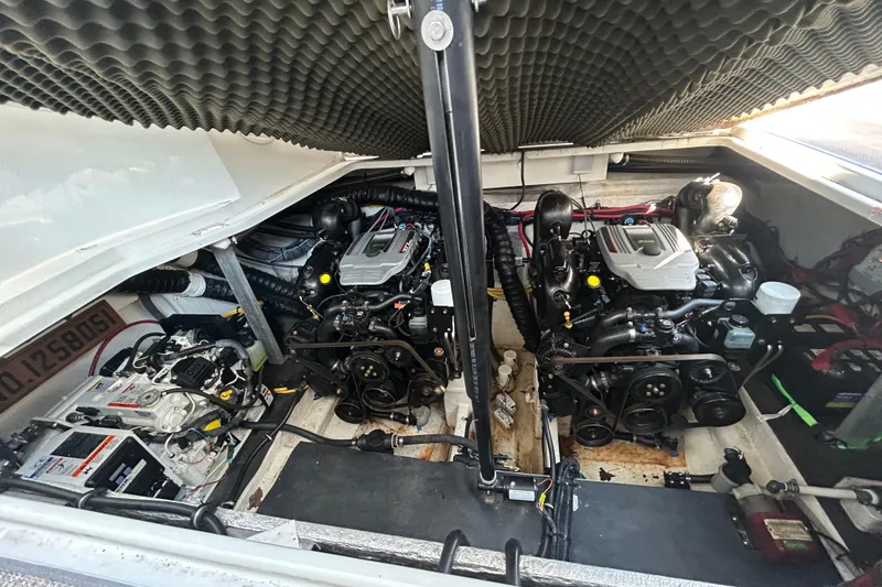 Slide: The Image of Engine compartment of a 2015 Crownline 350 SY boat, showcasing dual engines. - 33