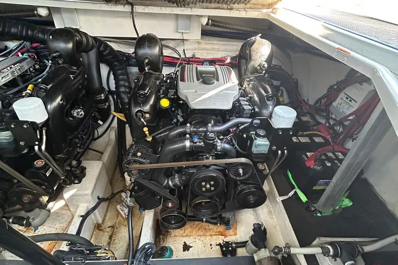 Slide: The Image of Engine compartment of a 2015 Crownline 350 SY boat, showcasing dual engines and components. - 34