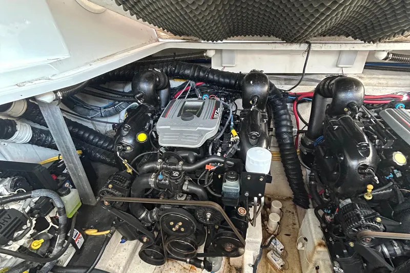 Slide: The Image of Engine compartment of a 2015 Crownline 350 SY boat, showcasing dual engines and components. - 37