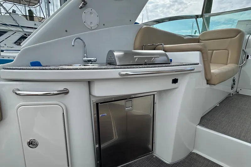 Slide: The Image of 2015 Crownline 350 SY yacht interior with kitchenette and seating area. - 38