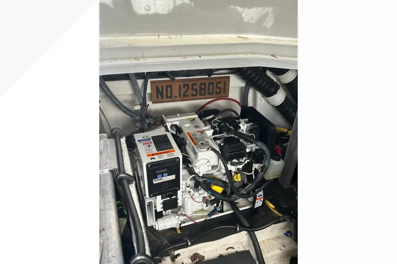 Slide: The Image of Engine compartment of a 2015 Crownline 350 SY boat, featuring mechanical components. - 41