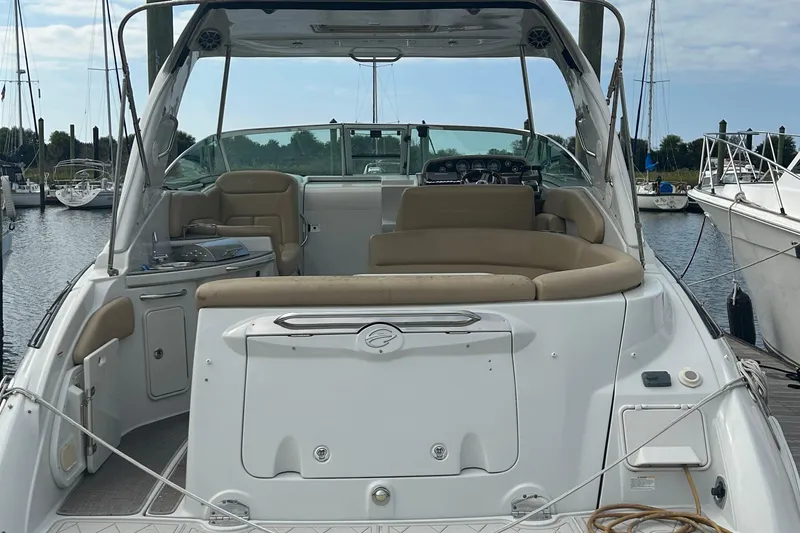 Slide: The Image of 2015 Crownline 350 SY yacht docked, featuring spacious seating and sleek design. - 46