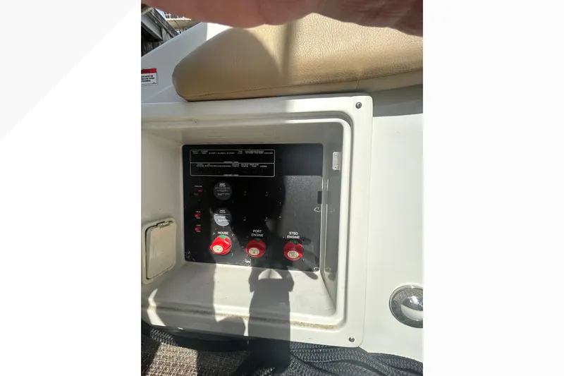Slide: The Image of Control panel of a 2015 Crownline 350 SY boat, featuring engine switches and settings. - 48