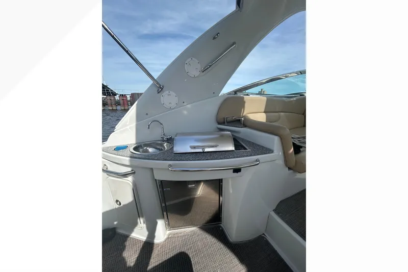 Slide: The Image of 2015 Crownline 350 SY yacht interior with kitchenette and seating area. - 49