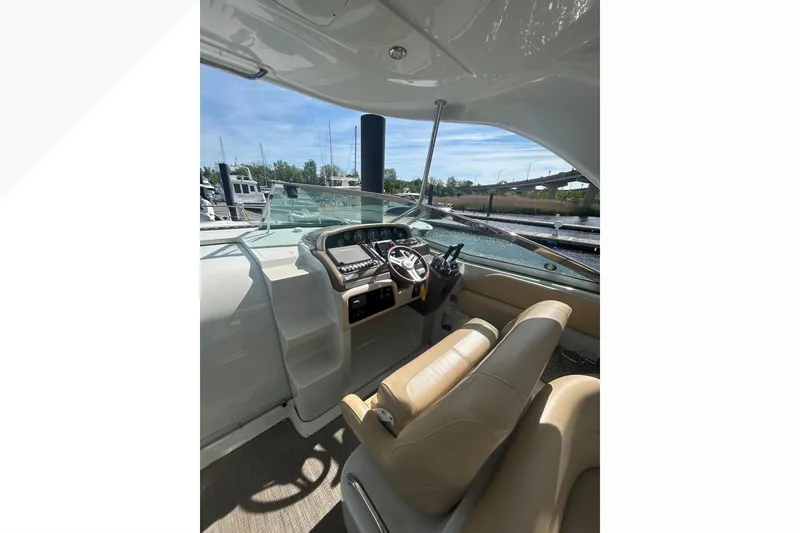 Slide: The Image of 2015 Crownline 350 SY boat interior with helm and seating area. - 51