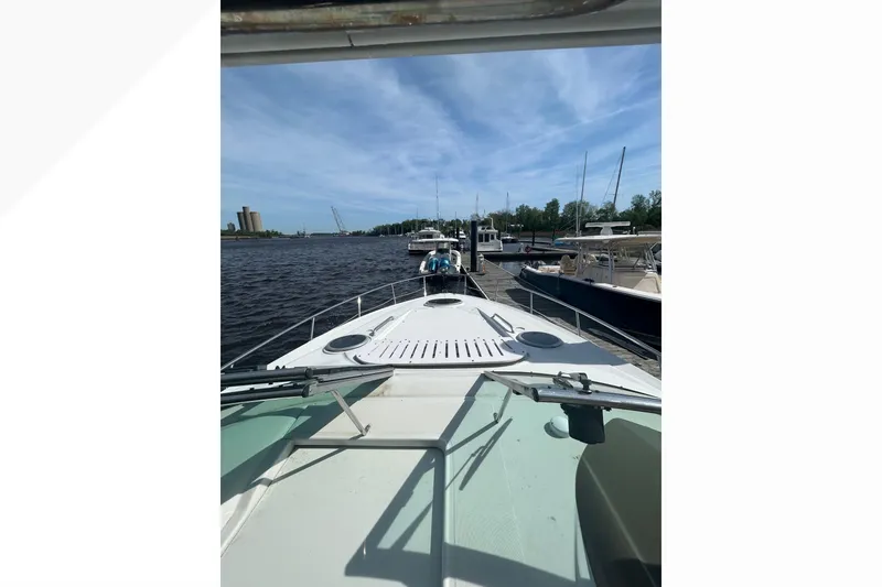 Slide: The Image of 2015 Crownline 350 SY yacht docked at a marina on a sunny day. - 54