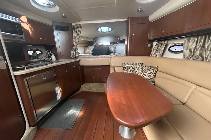 Slide: The Image of Interior of 2015 Crownline 350 SY yacht with kitchen and seating area. - 56