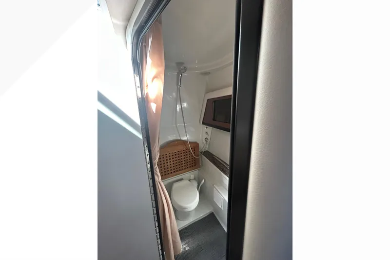 Slide: The Image of 2015 Crownline 350 SY boat bathroom with shower and toilet. - 59