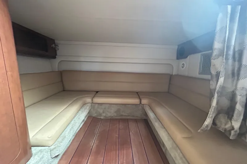Slide: The Image of Interior cabin of 2015 Crownline 350 SY with beige seating and wood flooring. - 60