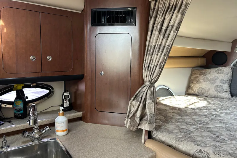 Slide: The Image of Interior of 2015 Crownline 350 SY yacht with cozy bed and kitchenette area. - 61