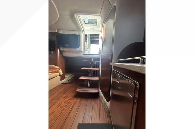 Slide: The Image of Interior of 2015 Crownline 350 SY yacht with wooden flooring and modern amenities. - 63
