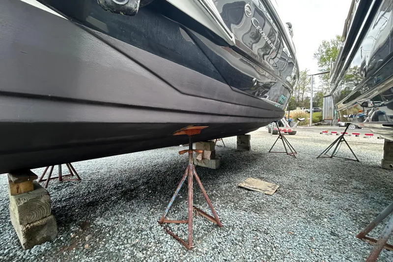 Slide: The Image of 2015 Crownline 350 SY boat on stands, displayed on gravel surface. - 64