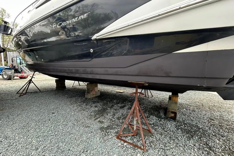 Slide: The Image of 2015 Crownline 350 SY boat on stands, displayed on gravel surface. - 68