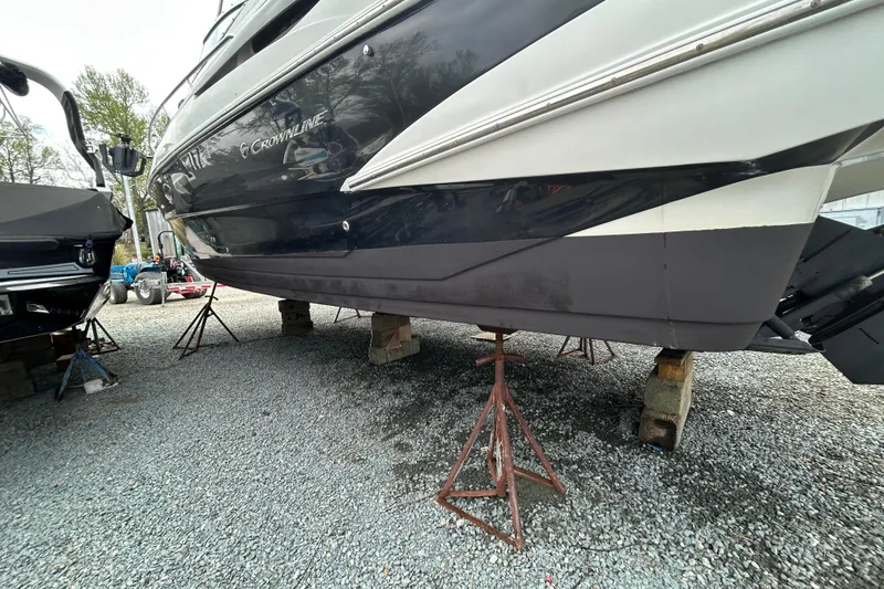 Slide: The Image of 2015 Crownline 350 SY boat on stands, displayed outdoors on gravel. - 69