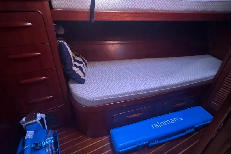 Slide: The Image of Cozy cabin interior of 1981 Gulfstar 60 CC sailboat with wooden furnishings and bedding. - 11