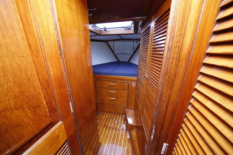 Slide: The Image of 1981 Gulfstar 60 CC yacht interior with wooden cabinetry and cozy sleeping area. - 12