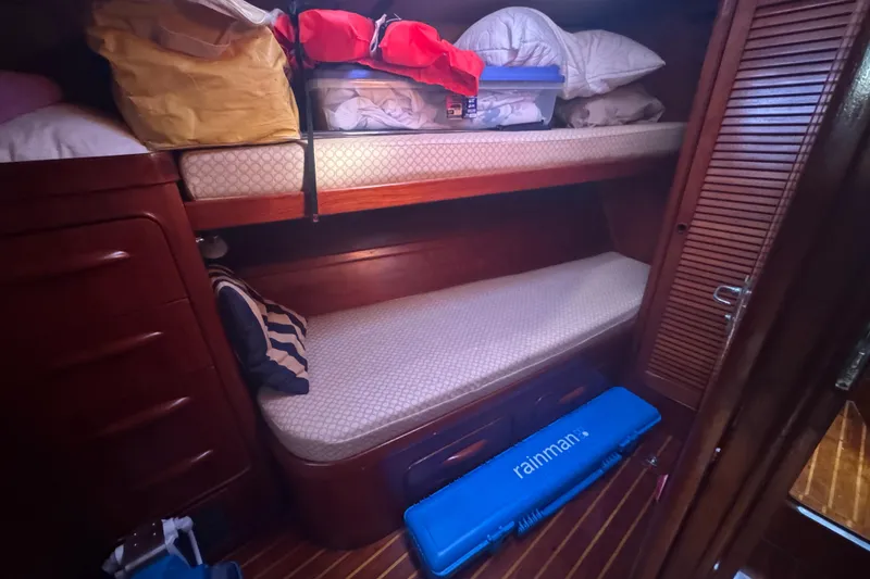 Slide: The Image of Cozy cabin interior of 1981 Gulfstar 60 CC with bunk beds and storage. - 19
