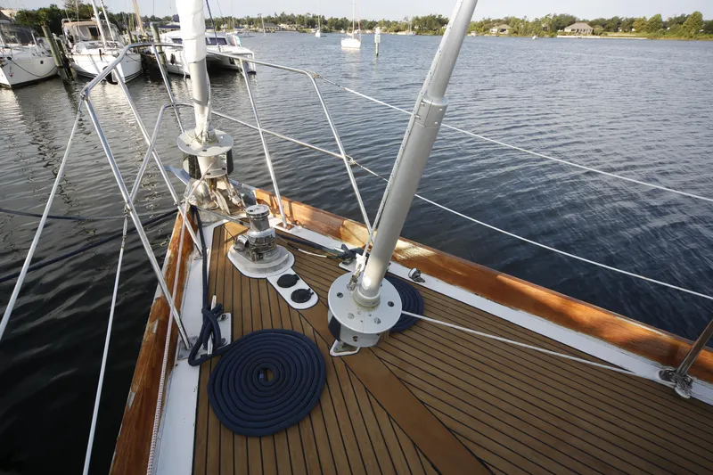 Slide: The Image of 1981 Gulfstar 60 CC sailboat deck with winches and ropes, docked in a marina. - 23