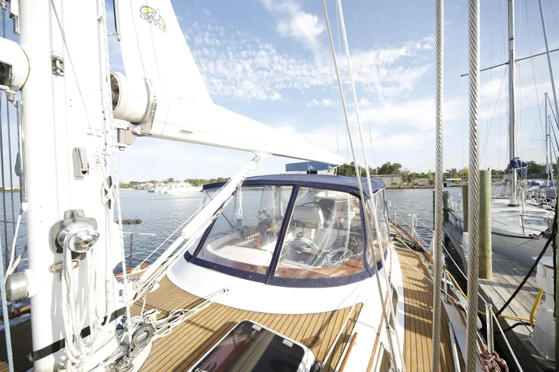 Slide: The Image of 1981 Gulfstar 60 CC sailboat docked, showcasing deck and cockpit under clear skies. - 24