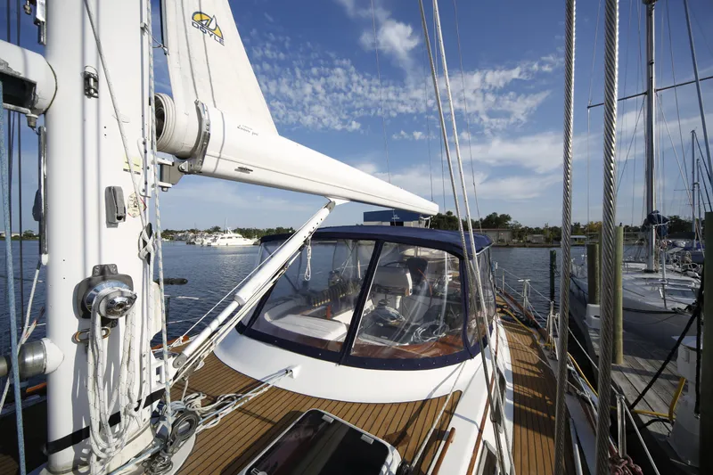 Slide: The Image of 1981 Gulfstar 60 CC sailboat docked, featuring a sleek deck and clear blue sky. - 25